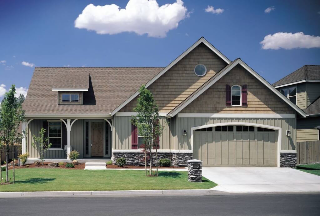 A lovely home with mixed siding. We like how the natural stone is paired with two different styles of vinyl siding. By Alan Mascord Design Associates.