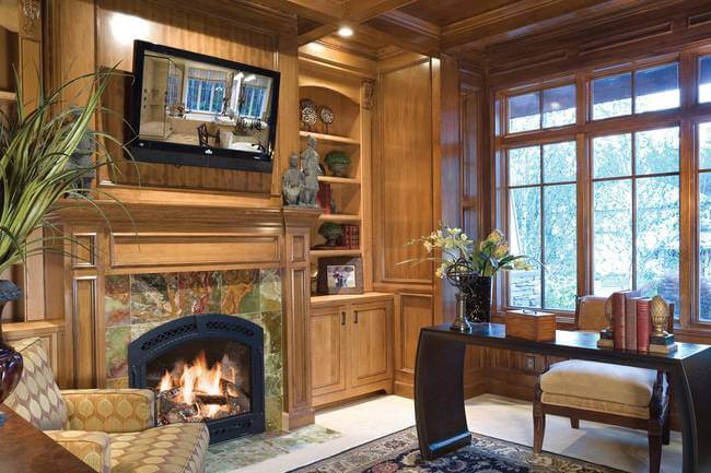 Wonderful rustic interior by Alan Mascord Design Associates. The fireplace and wood panels make the room feel ultra cozy.