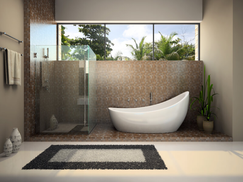 freestanding bathtub with glass enclosed walk-in shower and tile