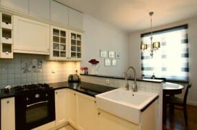 Farmhouse sink in a kitchen with white cabinets.