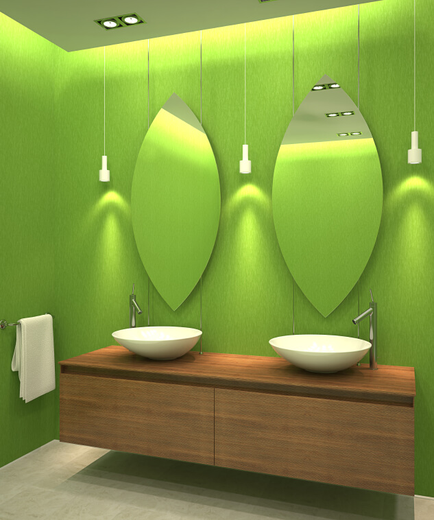 Image of wooden vanity against a bright green wall with unique mirrors and hanging white pendant lights