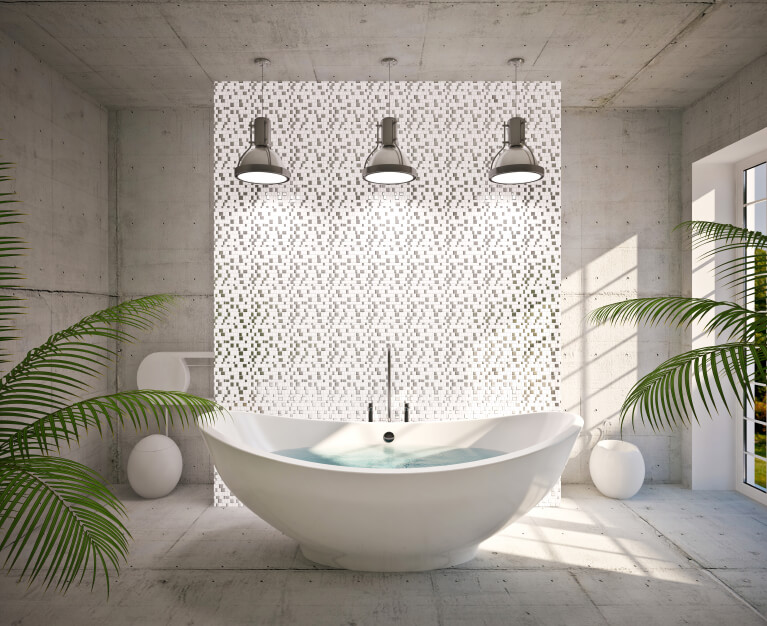 Image of a freestanding bathtub with three pendant lights hanging above