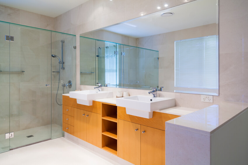 Double vanity with blonde wood and white sinks