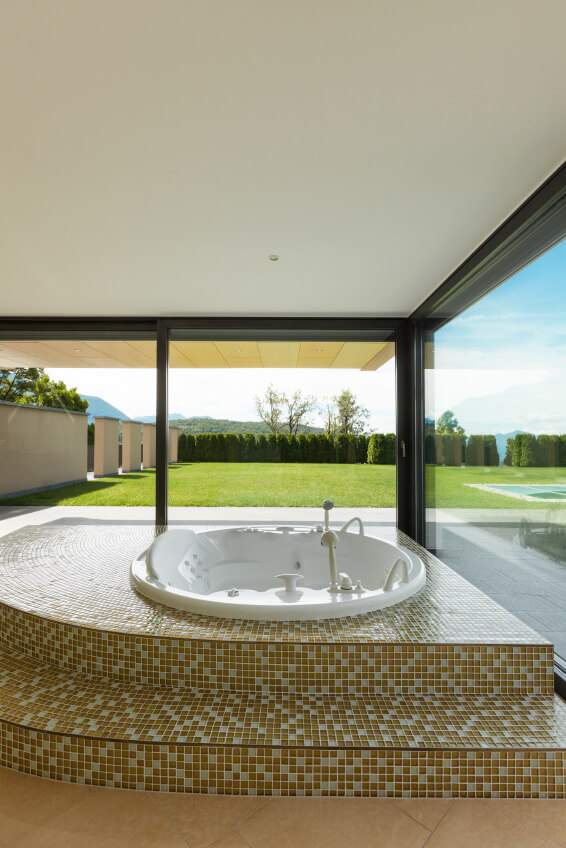 beautiful room with round jacuzzi tub and large windows