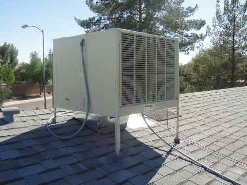 Image shows a swamp cooler installed on a roof