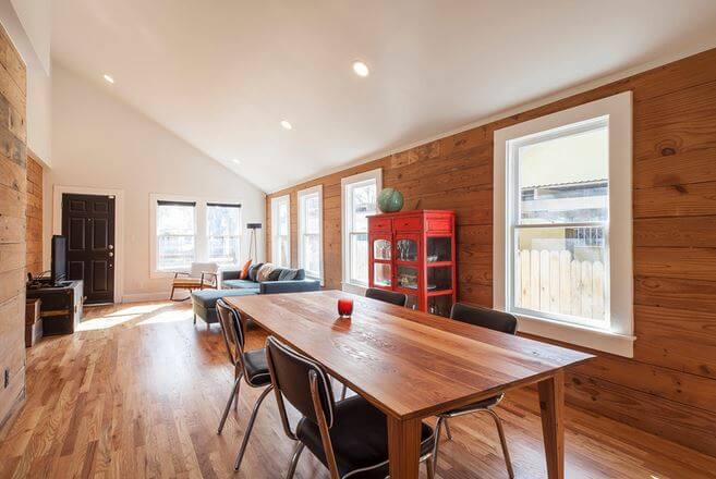 An open dining and living space in the Haskell home, designed by Maggie McIntosh of Moontower Design Build.
