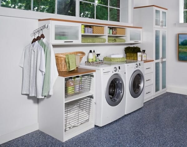 Image of a white laundry space with many baskets and drawers for storage