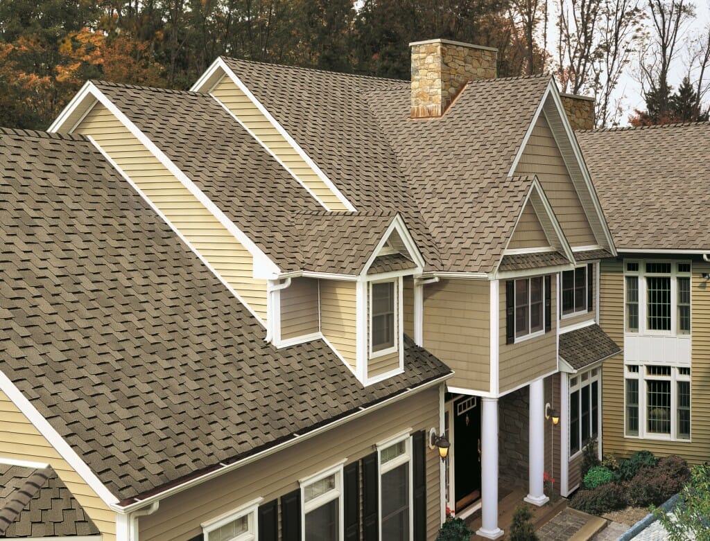 Image of a classic traditional home with light brown shingles