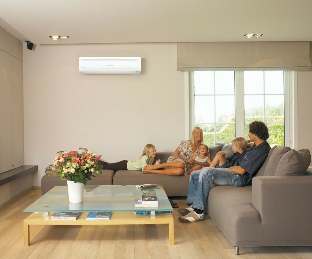 ductless mini split in a living room with a family sitting on the couch 