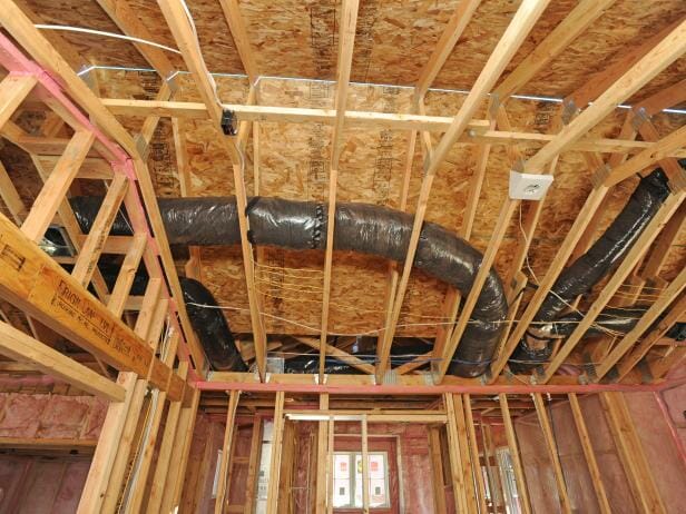Image of HVAC ductwork in a house at the framing stage of a build