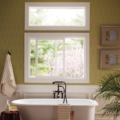 Pella sliding window above a white clawfoot tub