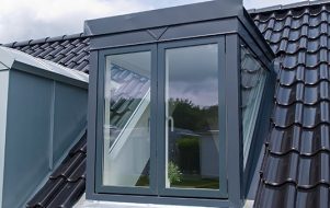 Casement window protrudes from the roof of a home.