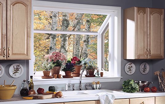 A large garden window in a kitchen