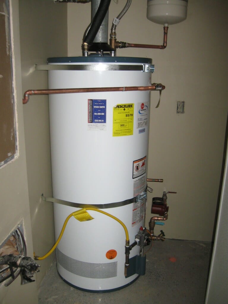Image of a medium-sized tank water heater installed in a garage nook