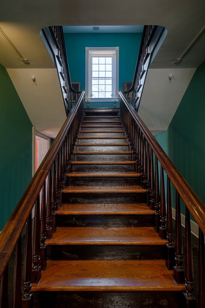 straight wooden stairs to basement