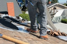 Image showing the legs of a contractor on a roof during a replacement