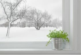 A home window with a view of snow outside