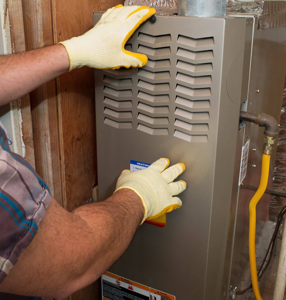 a contractor doing a manitenance check on a furnace 