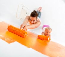 Mother and daughter painting a wall together