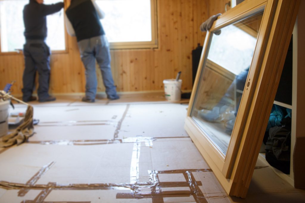 Workers installing new windows in a new build home