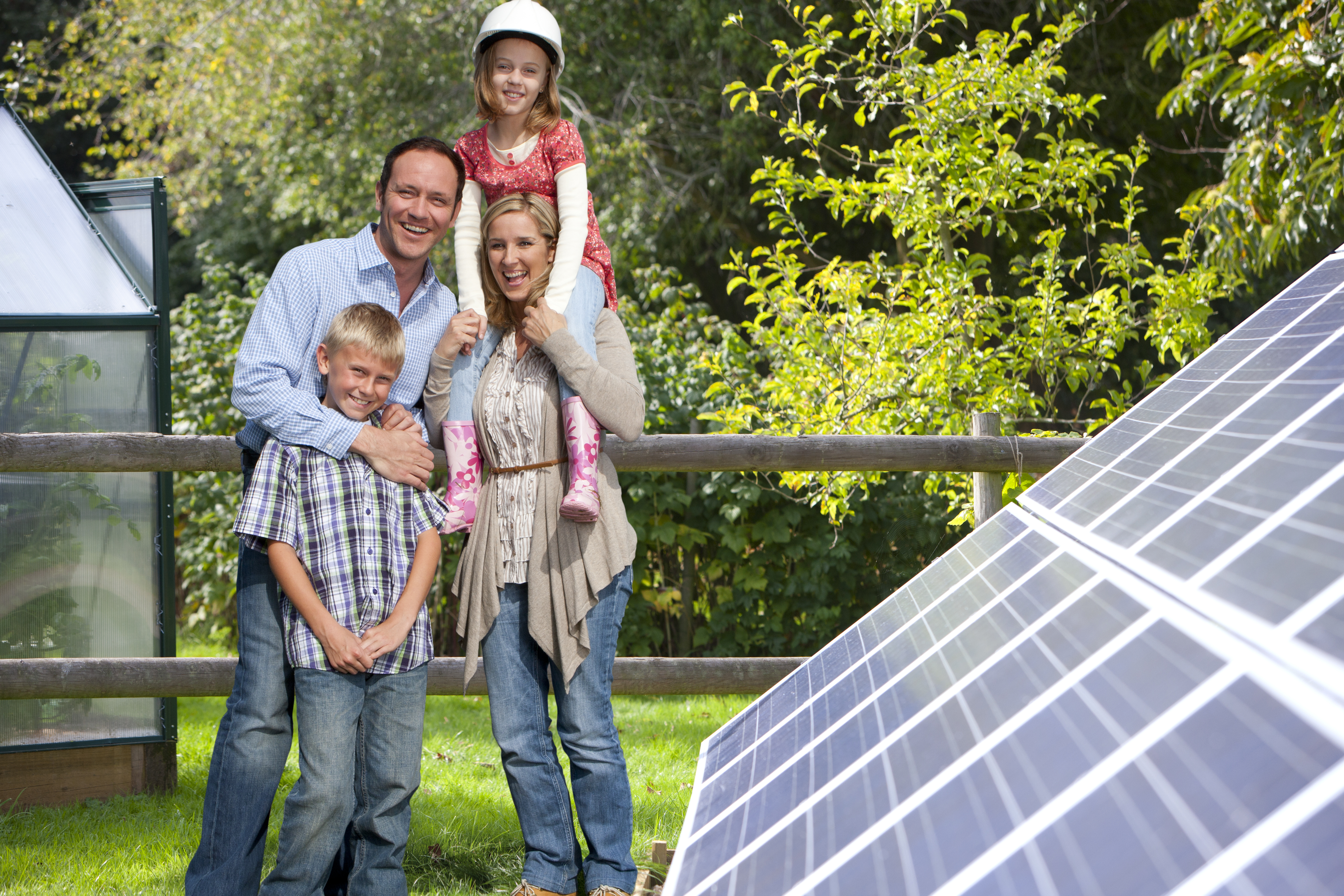 family in front of solar panels in the backyard