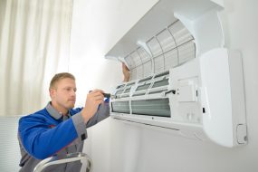 Contractor Repairing Air Conditioner