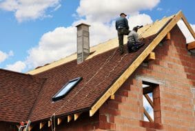 Image of contractor on a roof in the middle of a roof replacement