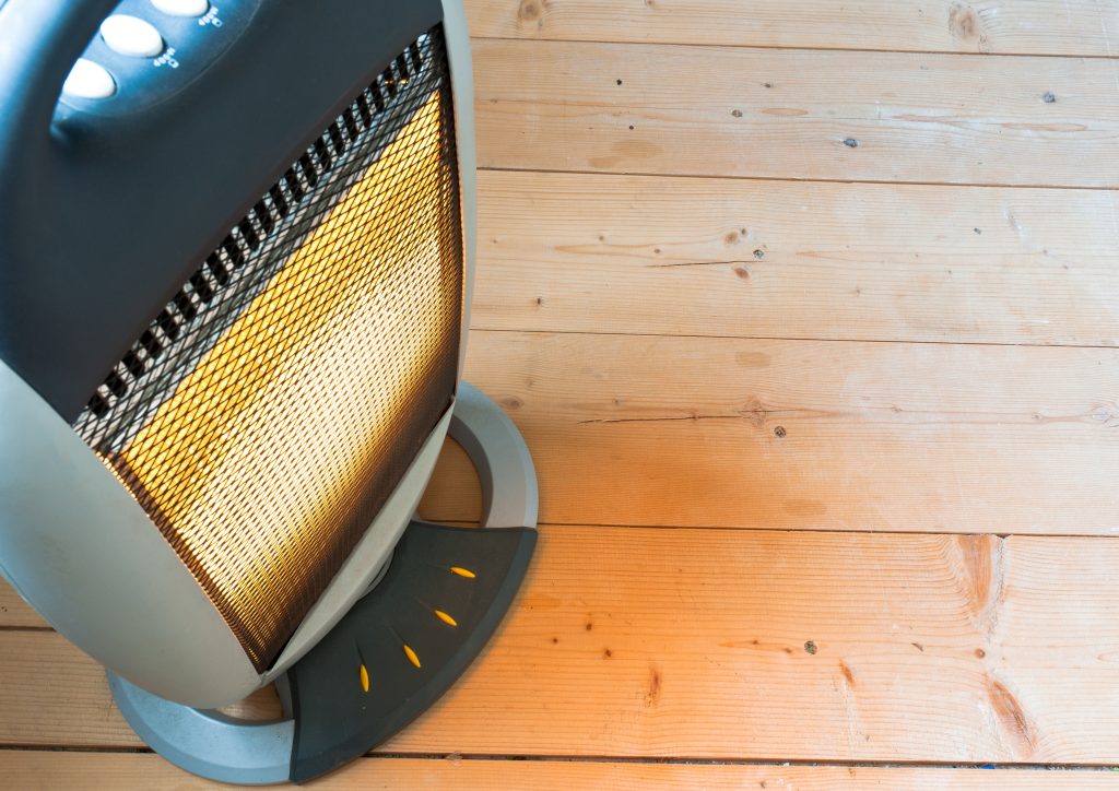 Halogen or electric heater on wooden floor