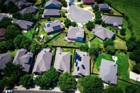 Ariel view of homes in a neighborhood with solar panels