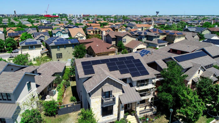 Aerial drone view of suburb neighborhood in East Austin community houses and homes - Mueller Suburb Solar Panel Rooftops and Modern Austin Living