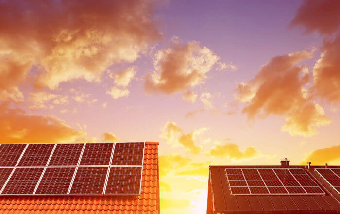 Solar energy panel on the roof of the house in the background sunset sky. The concept of ecological housing.
