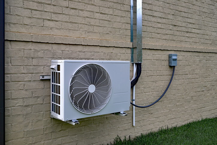 image showing a split system air conditioner unit mounted on a wall to explain what a split system ac is