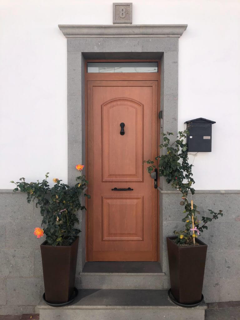 A front door painted a light shade of brown