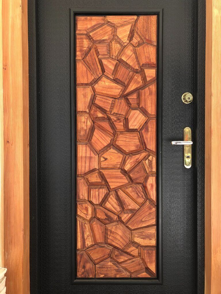 Black front door with natural wood accent