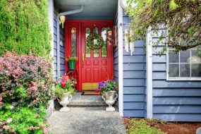 Red front door on a blue house