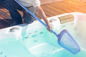 Person skimming a hot tub