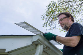 Professional installing gutter guards