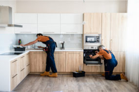 Image of two remodelers working in a kitchen remodel