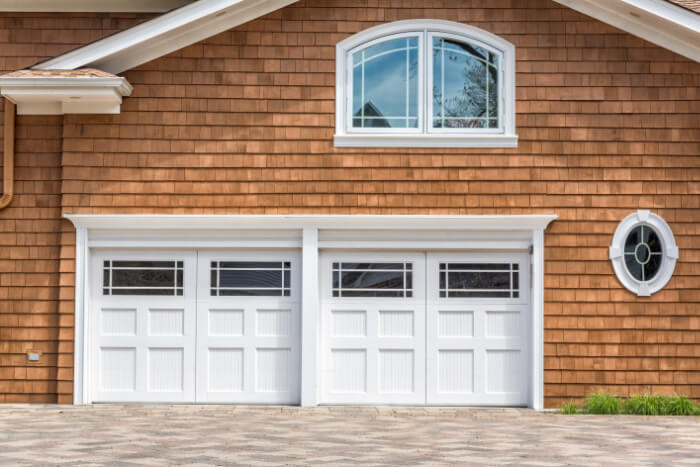 a home with cedar-wood-siding with two garages