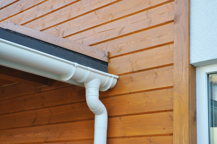 vinyl gutters on home with wood siding