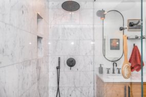 frameless shower next to a vanity