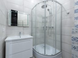 Round corner shower in a white bathroom