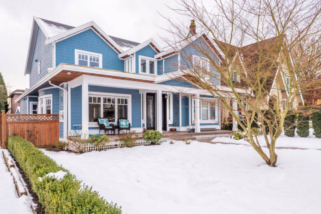 Home with blue vinyl siding and white trim