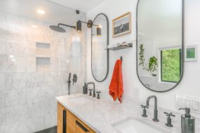 Bathroom with double vanity and frameless shower