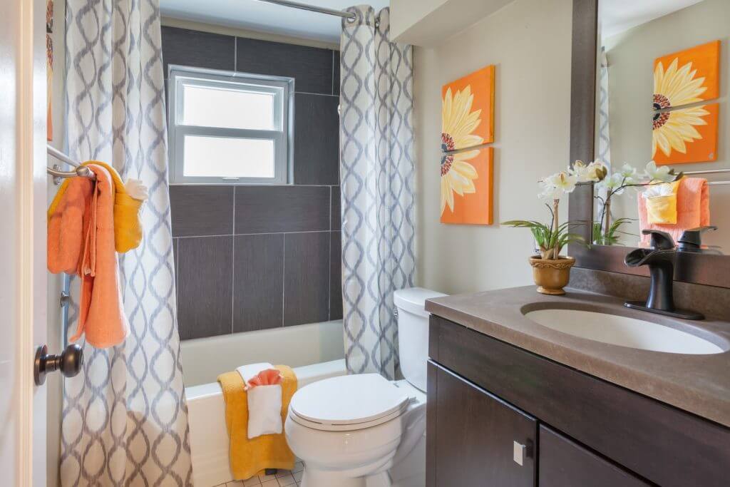 Large, gray tiles create a feature wall in a small bathroom