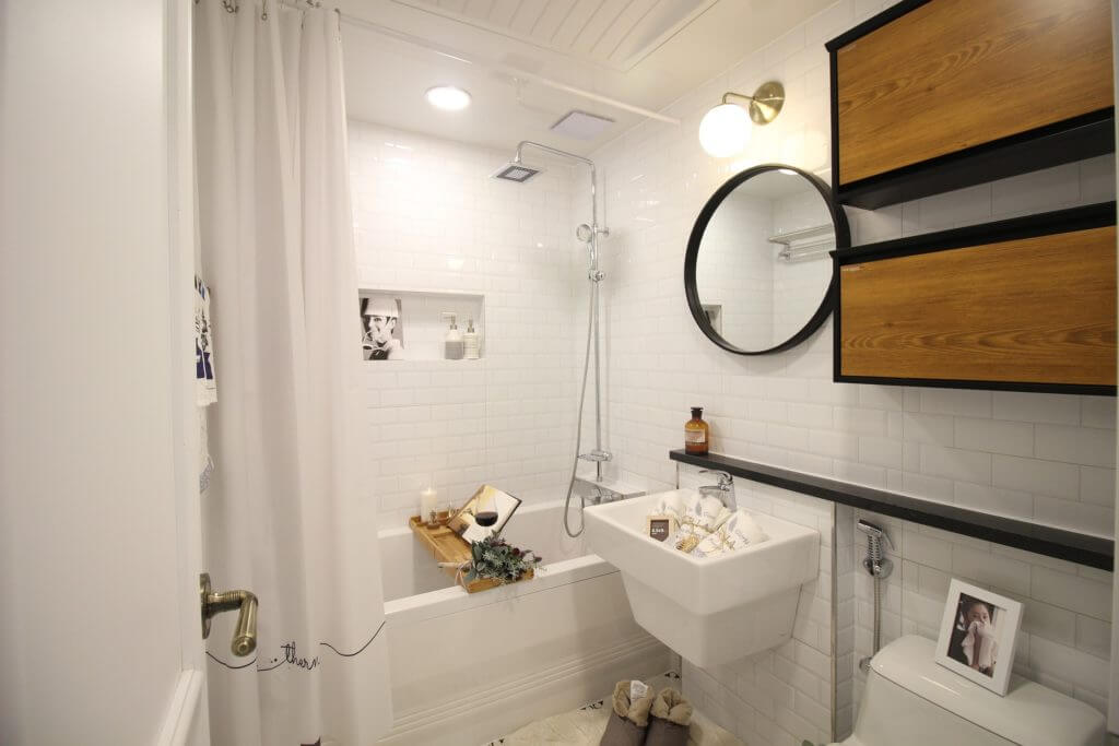 Small bathroom with white tile floors and walls and black and wood storage