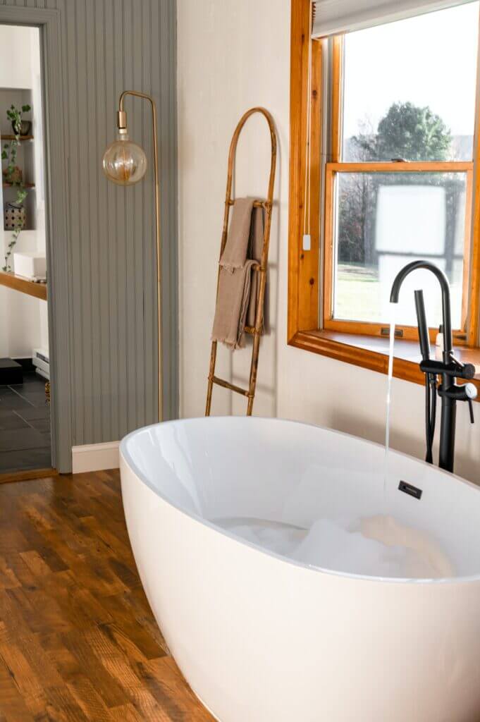 freestanding tub with black faucet