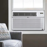 Image shows an LG window AC unit in a cozy room with a gray chair