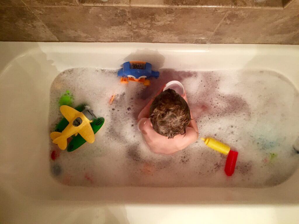 over head shot of a toddler in a bathtub with toys