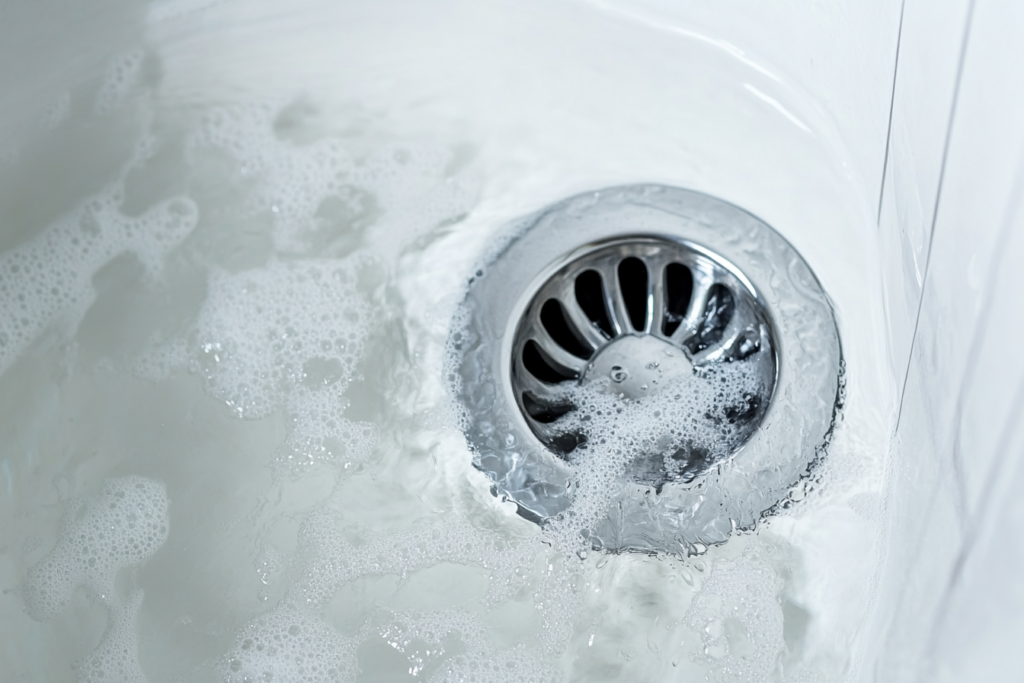 soapy water draining down the bathtub